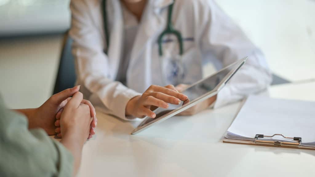 Physician reviewing blood glucose data with patient during GLP-1 weight loss consultation in Colorado Springs